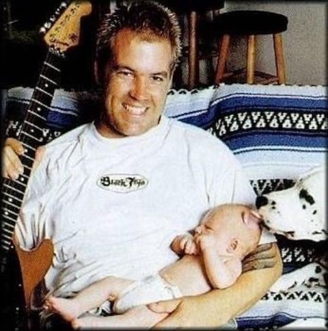 Bradley holding his newly born child, Jakob Nowell.